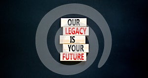 Legacy and future symbol. Concept words Our legacy is your future on wooden blocks. Beautiful black table black background.