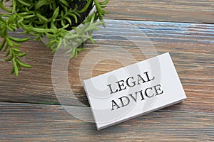 Legal Advice. Business card with message and flower. Office supplies on desk table top view