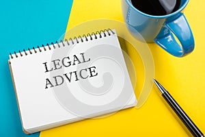 Legal Advice. Notepad with message, coffee cup, pen. Office supplies on desk table top view