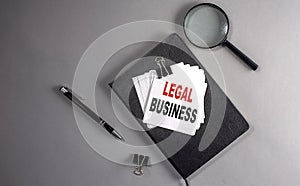 LEGAL BUSINESS Text on a sticky on black notebook , business concept