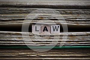 Legal conditions framework concept: Closeup of isolated antique old book pile text blocks and yellowed pages with wooden alphabet photo