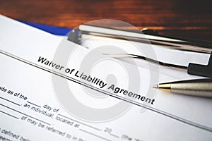 Legal document Waiver of Liability Agreement on paper close up photo