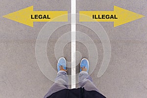 Legal or Illegal text on asphalt ground, feet and shoes on floor