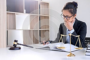Legal law, advice and justice concept, Professional Female lawyers working on courtroom sitting at the table and signing papers w photo