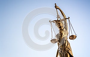 Legal law concept statue of Lady Justice with scales of justice sky background