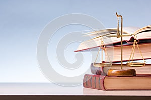 Legal Law and Justice concept - Open law book with a wooden judges gavel on table in a courtroom or law enforcement office. Copy