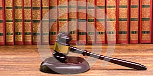 Legal Law and Justice concept - Open law book with a wooden judges gavel on table in a courtroom or law enforcement