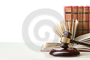 Legal Law and Justice concept - Open law book with a wooden judges gavel on table in a courtroom or law enforcement office. Copy