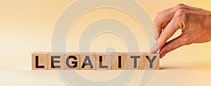 LEGALITY word written on wood block on a yellow background photo