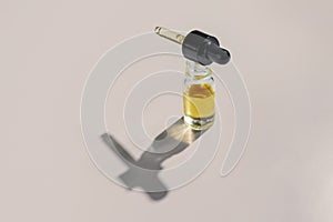 Legalized CBD oil in clear, glass container with dropper lid isolated background