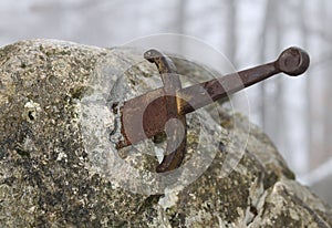 legendary Excalibur sword into the stone in the middle of the forest