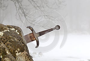 legendary Excalibur sword into the stone in the middle of the forest