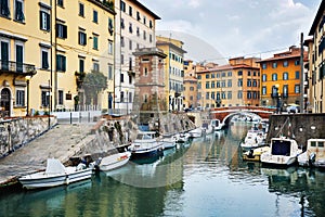 LEGHORN, ITALY - OCTOBER 3, 2017: Boats moored on canal in Venezia Nuova district of Livorno, Tuscany. Travel scenic cityscape photo