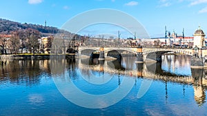 Legion Bridge, Czech: Most legii, reflected in Vltava River with Prague Castle and Petrin Hill on background. Clear