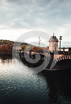 Legion Bridge in Prague (Czechia) on autumn sunset with Vltava river on foreground.