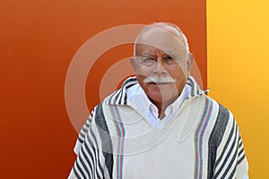 Legit Hispanic senior man wearing a ruana photo