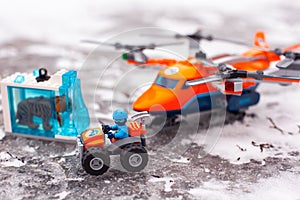 Lego all-terrain vehicle with explorer, saber-toothed tiger in ice and heavy-duty quadrocopter with 4 spinning rotors on ice