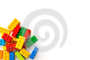 Lego background. Bunch of Colorful Plastick constructor bricks on white background. Popular toys. Copyspace