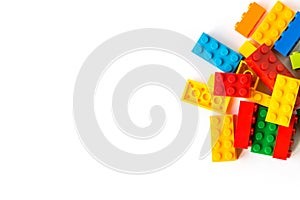 Lego background. Bunch of many Colorful Plastick constructor bricks on white background. Popular toys. Copyspace