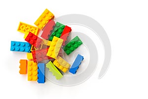 Lego background. Bunch of Multicolor Plastick constructor bricks on white background. Popular toys. Copyspace