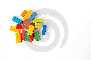 Lego backround. Multicolor Plastick constructor bricks on white background. Popular toys. Copyspace
