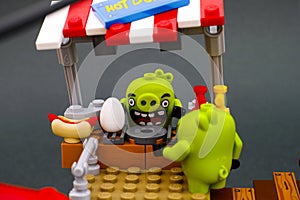 Lego Bad Piggy behind Hot Dogz stand ready to cook egg for his customer