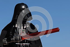 Lego Star Wars figure of Darth Vader holding red lightsaber