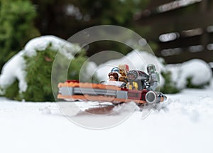 lego star wars minifigures droid r2d2 c3po lando and han solo riding on speeder during winter