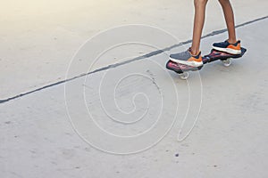 Legs of Asian boy having fun with play snakeboard on the cement floor is a activities relaxing lifestyle.