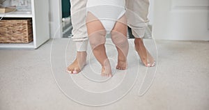 Legs, baby learning to walk with growth and development, parents and early childhood with motor skills. Family, support