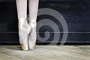 Legs of a ballerina in pointe shoes. Copy space.