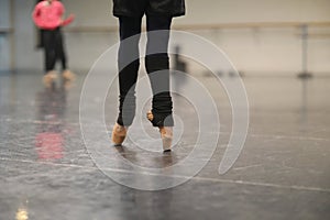 Legs of a ballerina standing on pointe