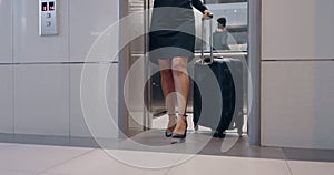 Legs, business and woman with suitcase, elevator and arrive in office, walking and travel. Female entrepreneur, boss and