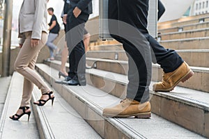 legs of businessmen walk stepping down stair in modern city hurry time, rush hour to work .business concept
