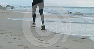 legs close-up Running female runner jogging during outdoor workout on beach