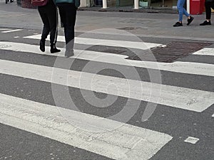 Legs crossing the road