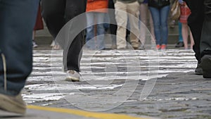 Legs of Crowd People Walking on the Pedestrian Crossing in Slow Motion