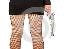 Legs of dangerous woman with handgun and black shoes