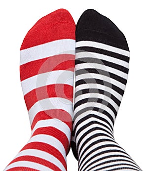 Legs in different striped socks.