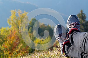 Legs of female hiker enjoying spectacular view in autumn