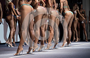 Legs of fitness bikini contestants.