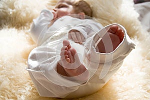 Legs foot of an infant with small baby fingers