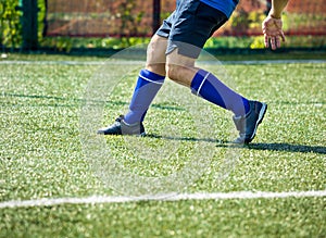 Legs of football players in action