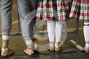 Legs of girls and boys in ethnographic costumes