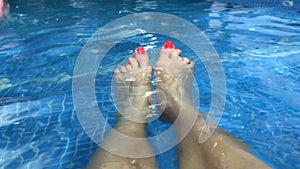 Legs of girls in the pool, relax