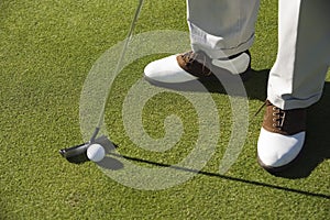 Legs With Golf Club And Ball On Grass