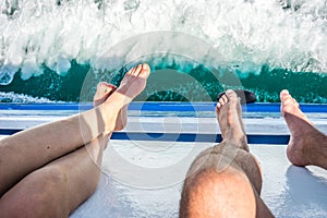 Legs hanging out of boat