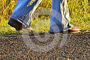 Legs hiker boots shoes woman walking country road