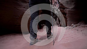 Legs Hiker Hiking On Dry Riverbed In Slot Canyon With Smooth Sandstone Walls