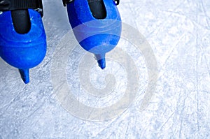 Legs of an ice skater in old vintage skates. Ice skratched background